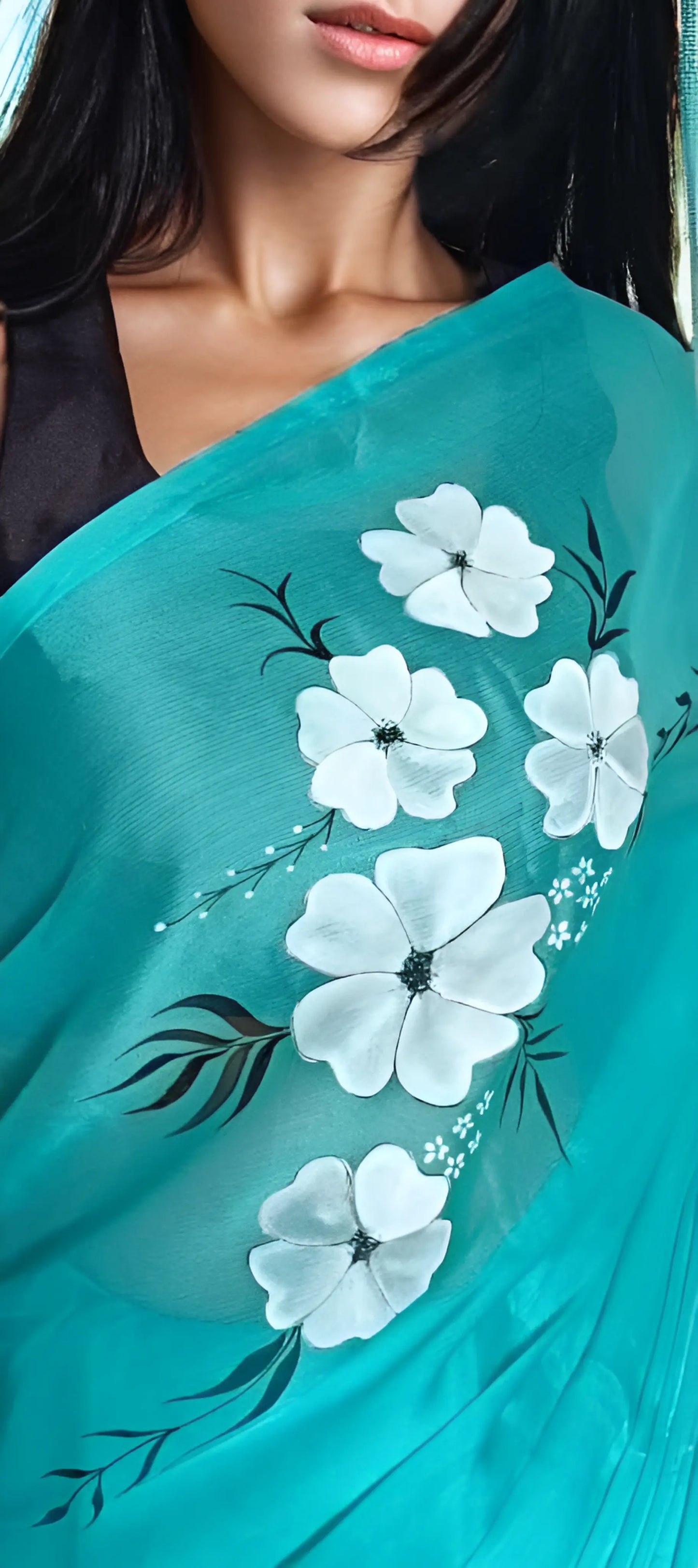 Close-up of hand-painted floral designs on the aqua saree