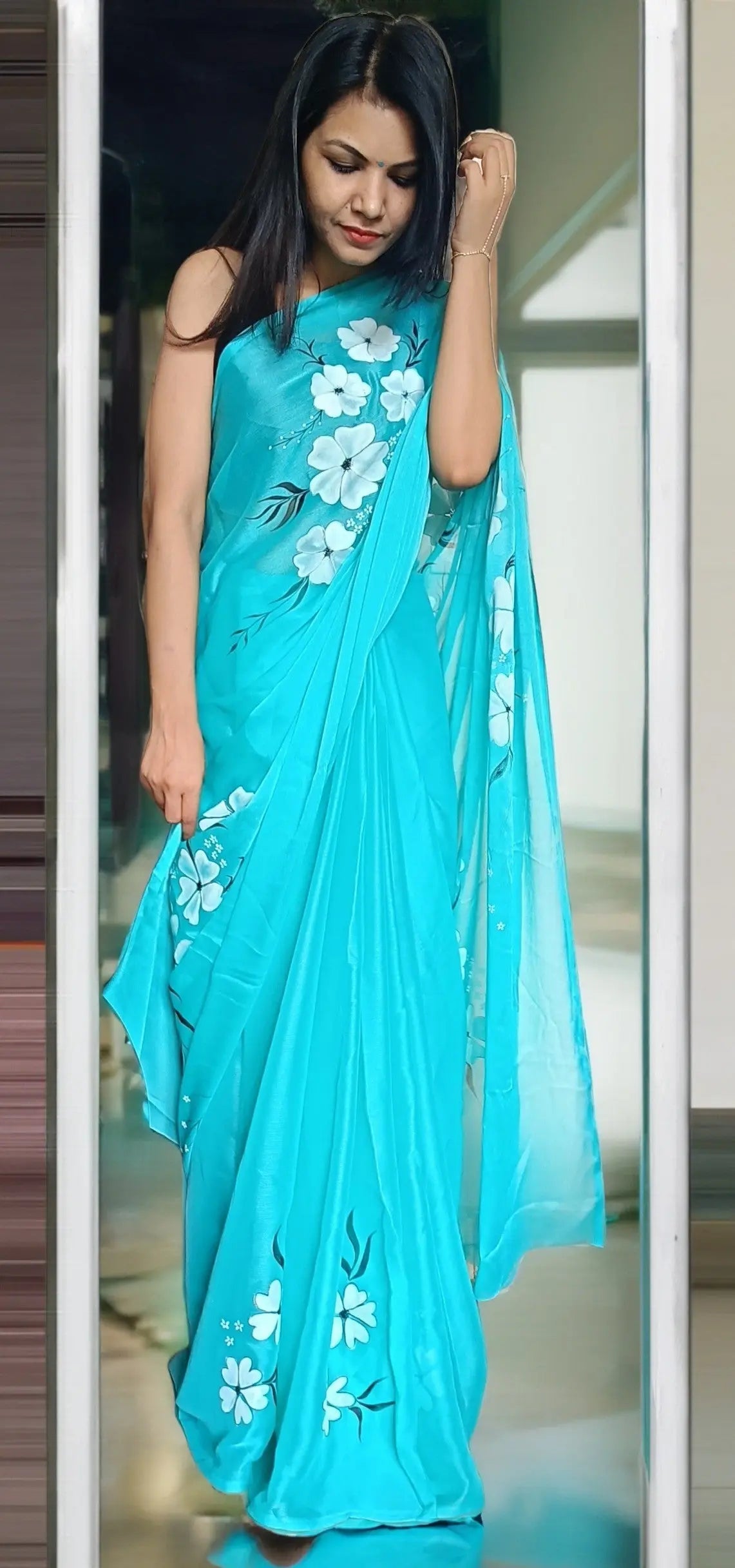 Full-length view of the aqua colour hand painted saree draped elegantly